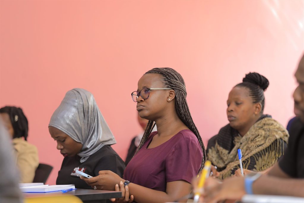 AIHS students, including one in an Ahaki Institute shirt, engaged in a classroom lecture