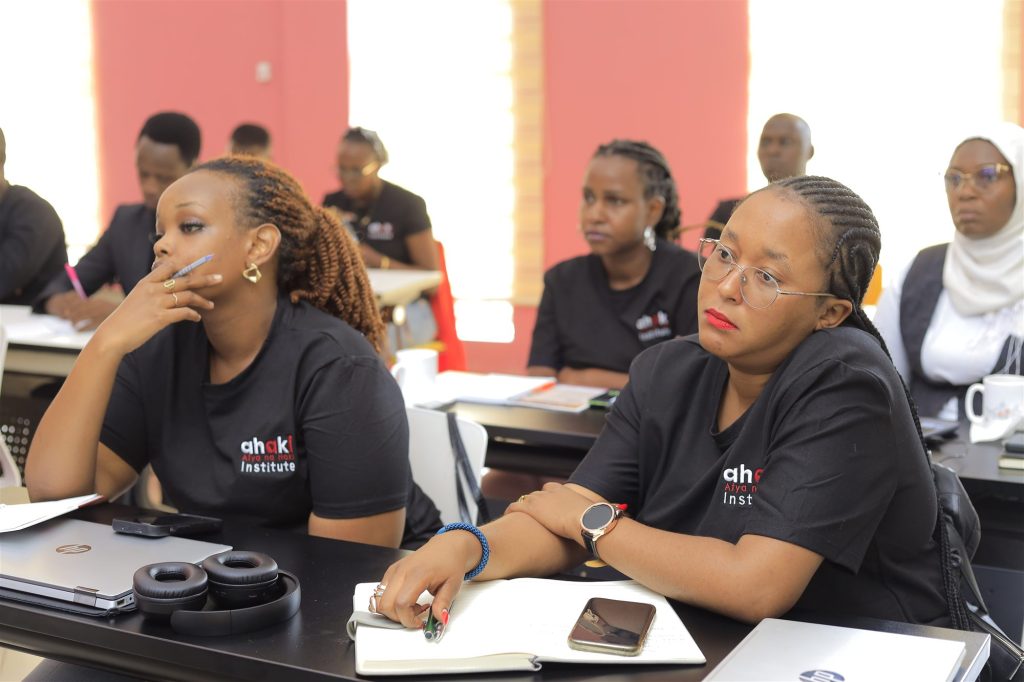 AIHS pioneer cohort students in a classroom, wearing Ahaki Institute shirts