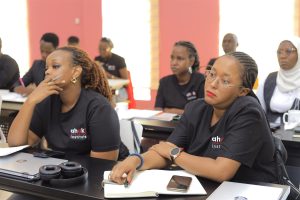 AIHS pioneer cohort students in a classroom, wearing Ahaki Institute shirts