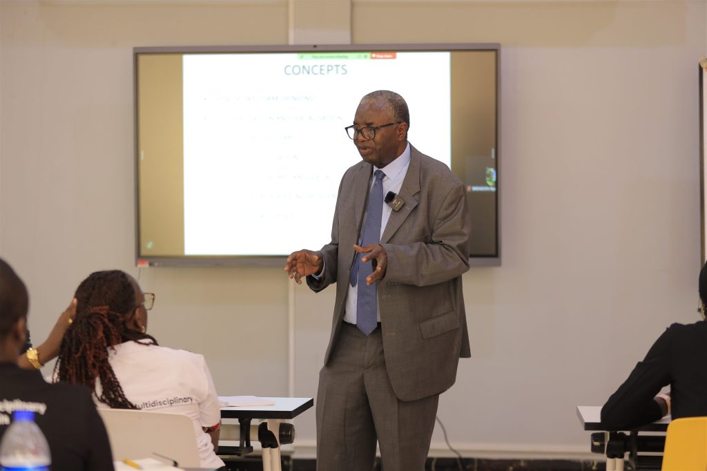 An AIHS faculty member teaching, with students in the foreground
